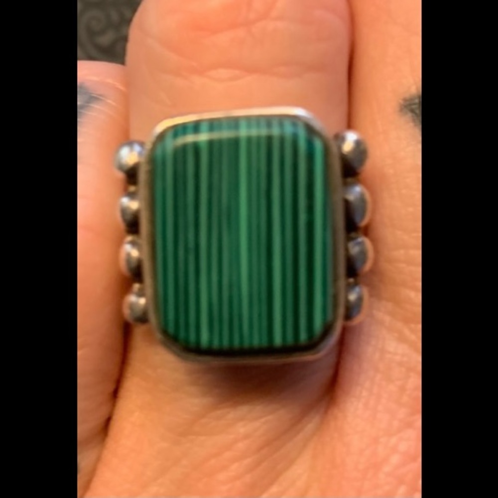 Green striped stone with silver balls on the side